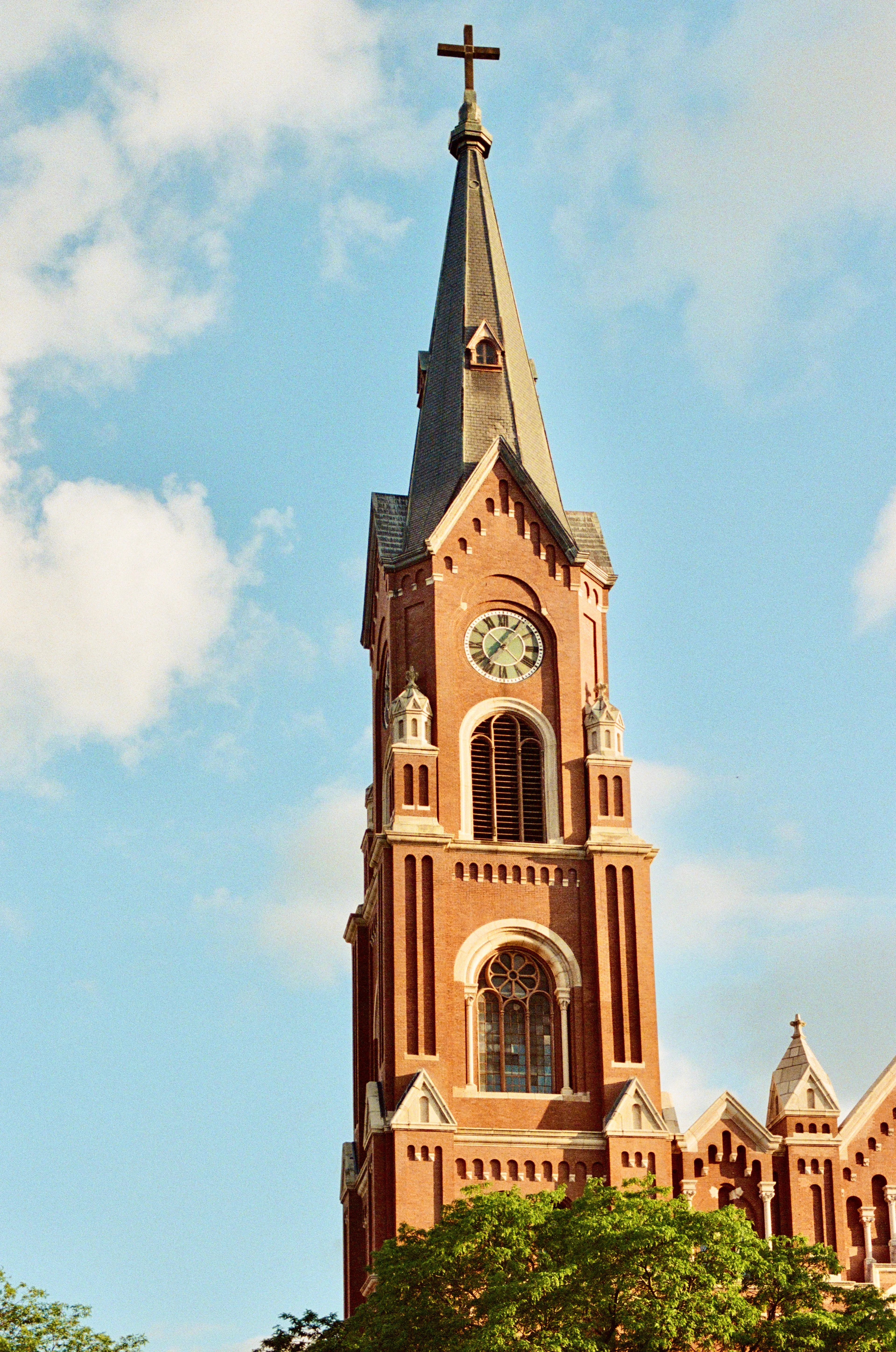 A red brick church steeple against a blue sky in Chicago