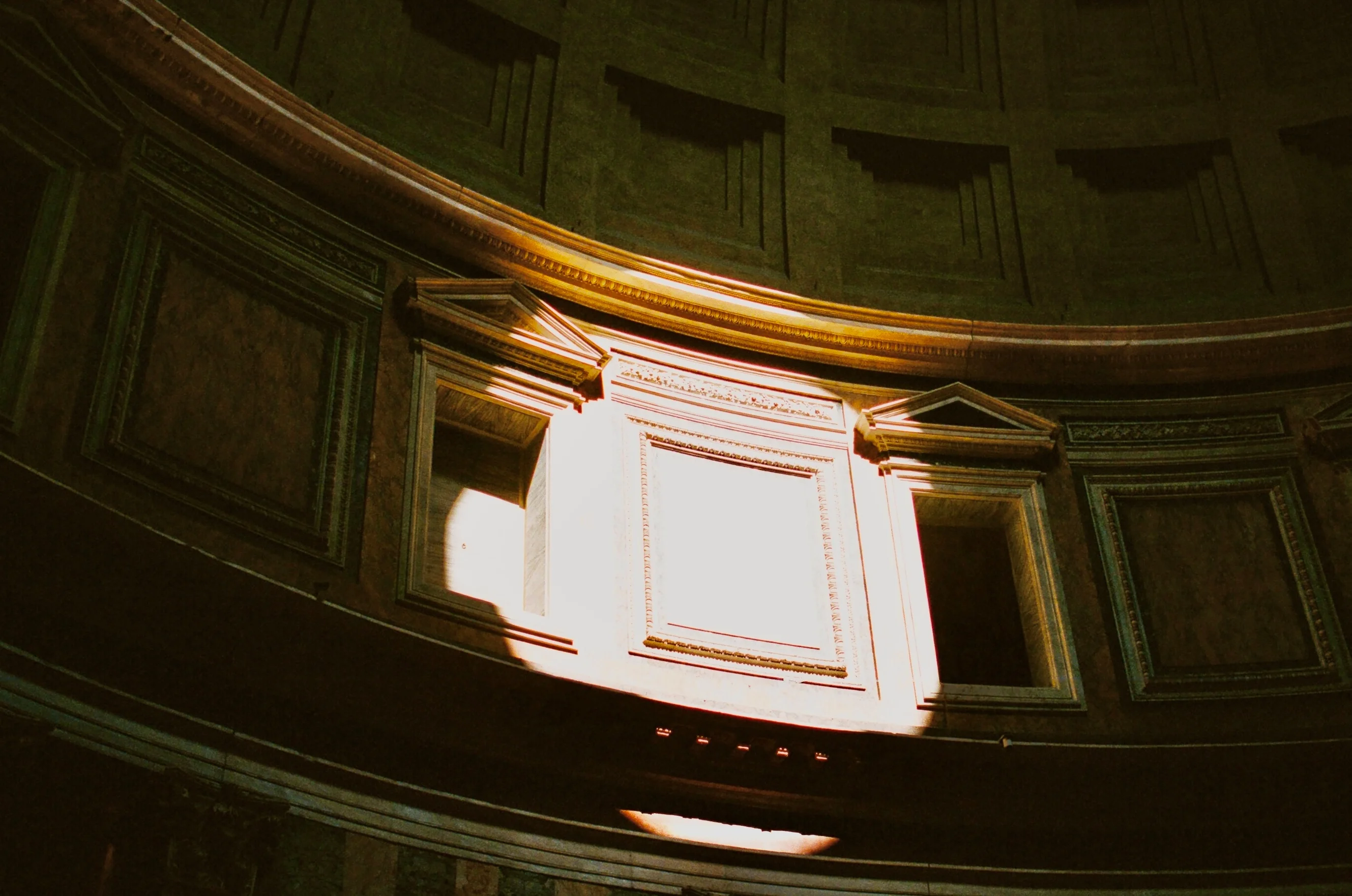 Sunlight entering a dark interior through a high window in Rome