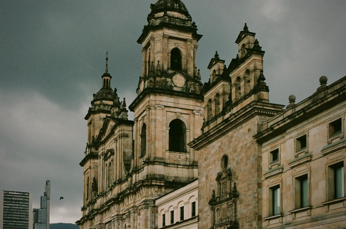 Twin church towers beneath an overcast sky in Bogota