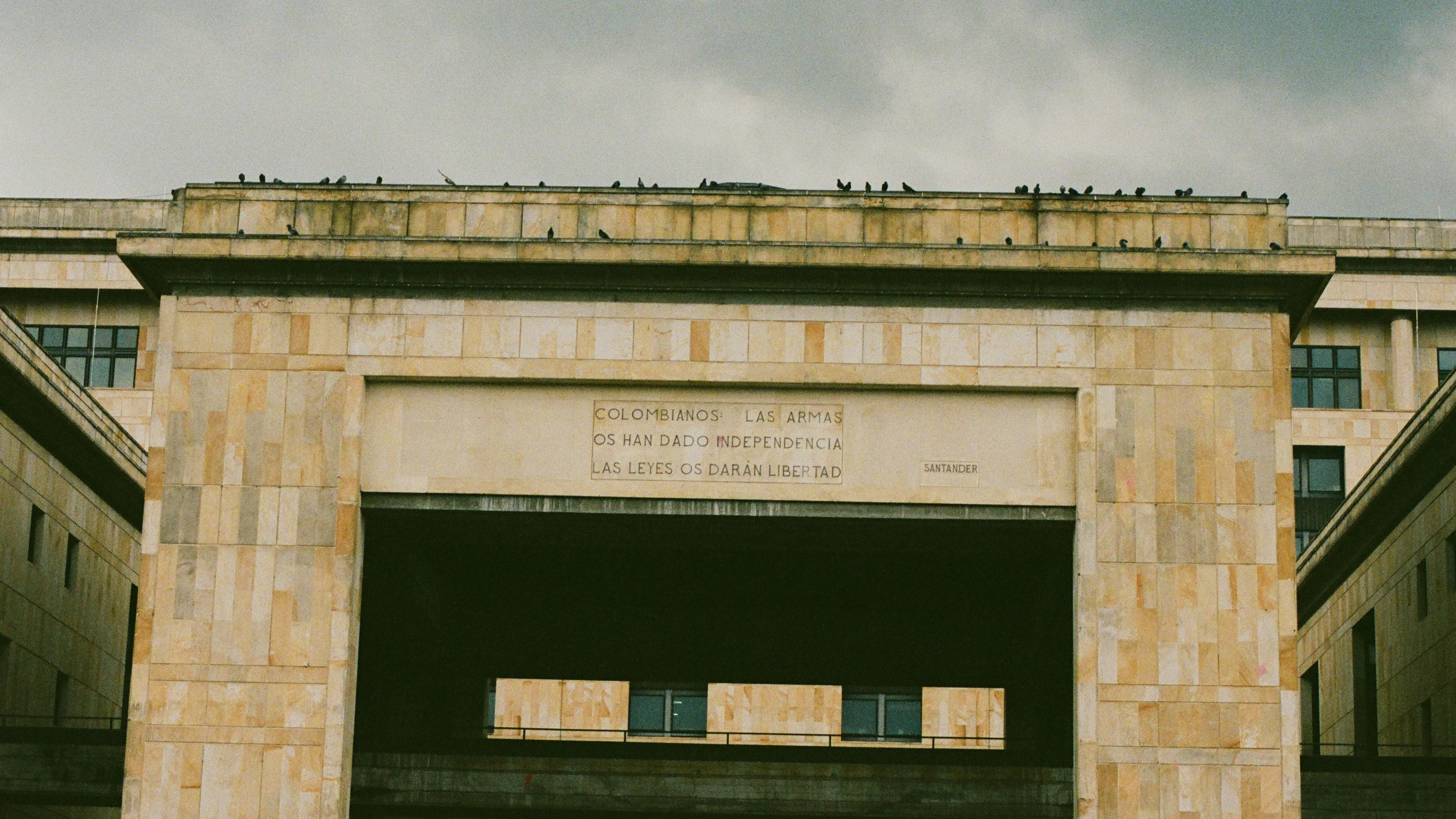 A monumental stone facade with a deep rectangular entrance in Bogota