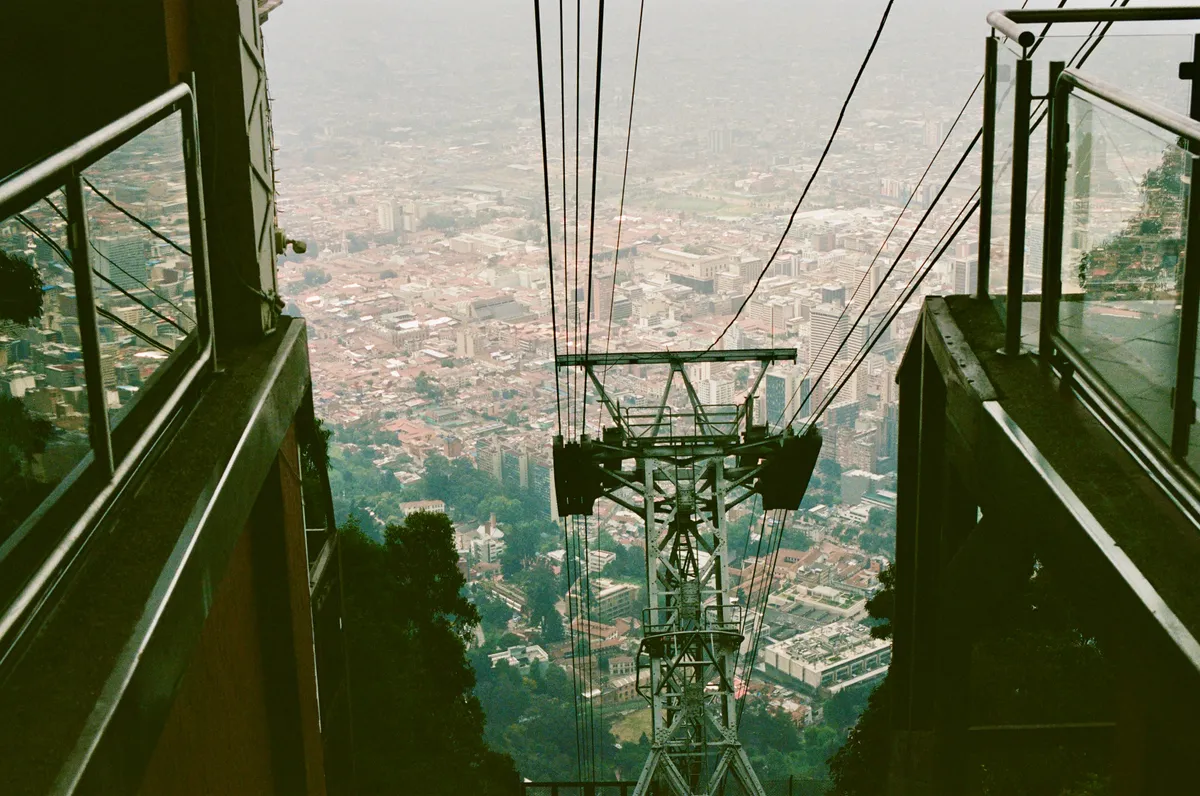 A cable car descending toward the city below in Bogota